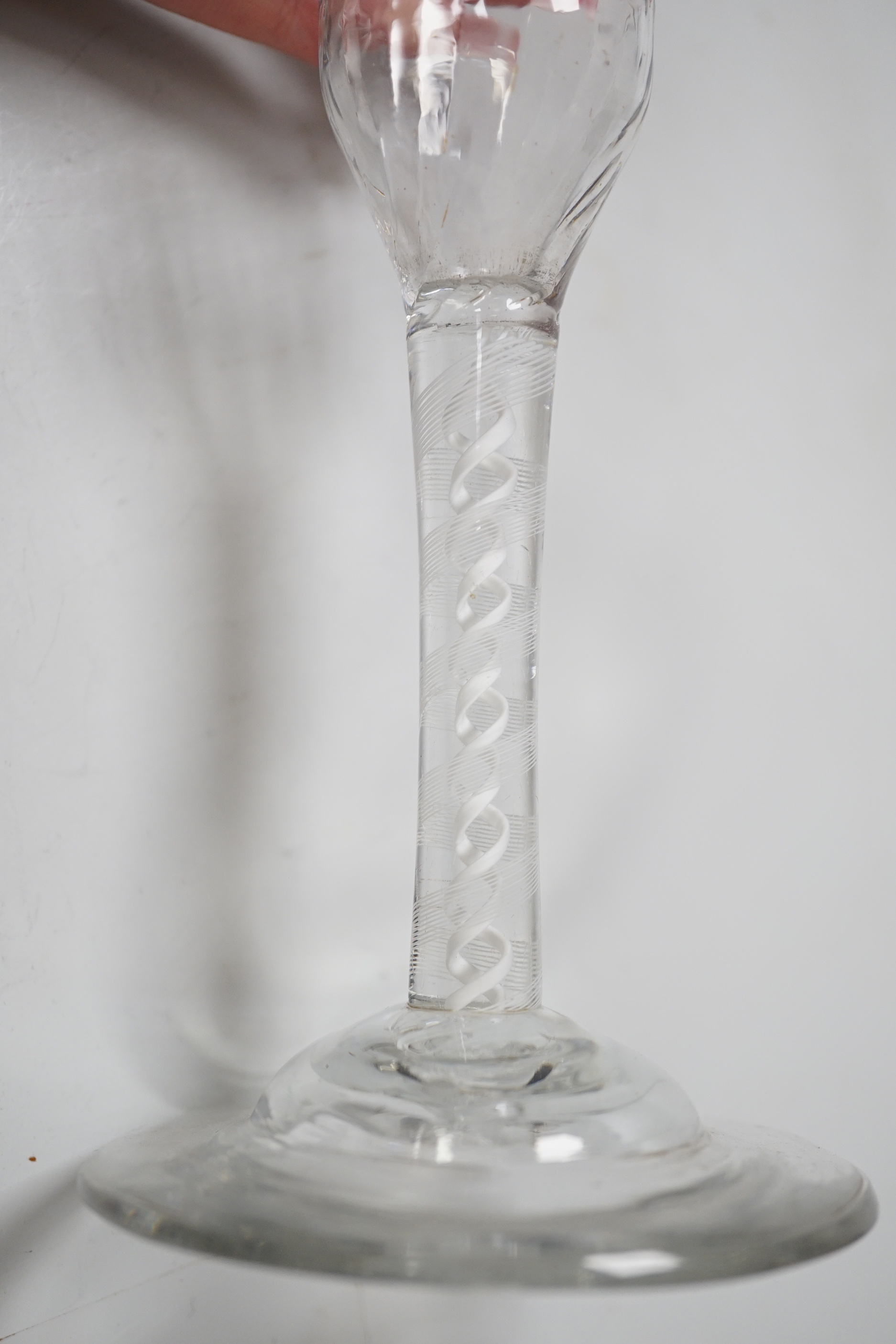 An English lead crystal ratafia glass, c.1750-60, the bowl is slightly waisted and elongated with an ogee finish and basal moulding, DSOT two spiral tapes inside rare eleven ply thread, domed foot, tool marked bowl and r
